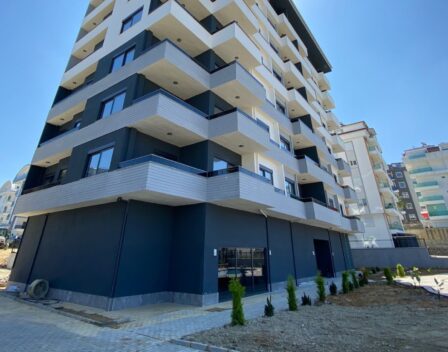 Omöblerad ny lägenhet till salu i Alanya med pool och trädgård 1